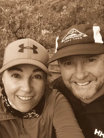 A close selfie in cycling jackets and caps