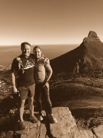 Standing on a rock high above the sea, a peak rising behind them