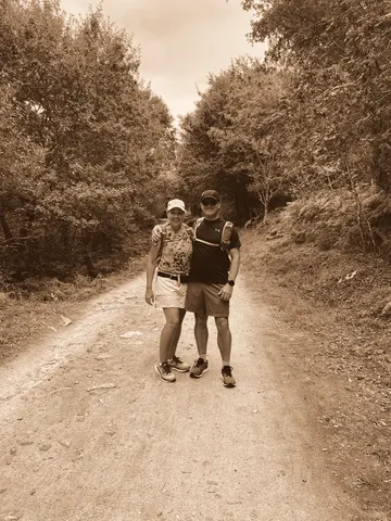 Walking away up a dirt track between trees
