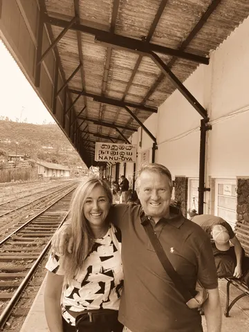 On a railway platform under an iron canopy