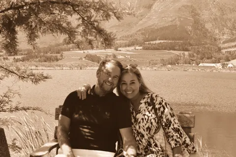 By the water with a mountain range across the lagoon